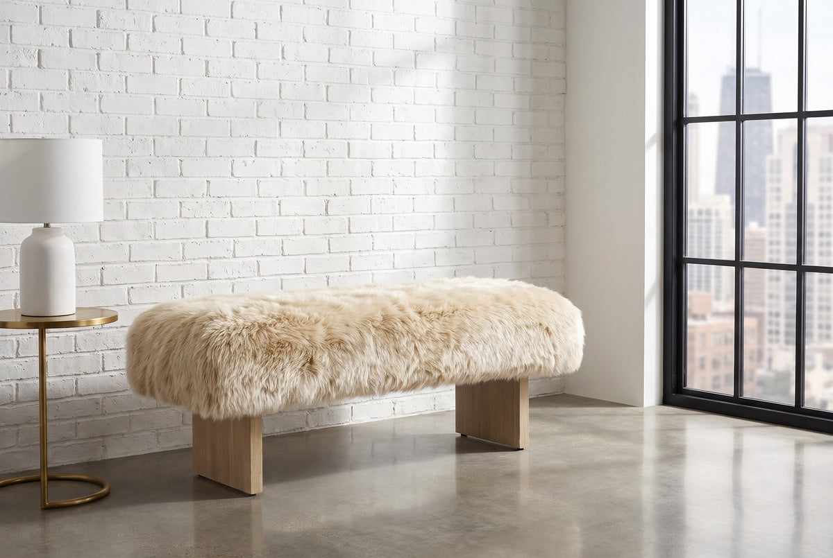 Narni sheepskin bench along a white-painted brick wall in a Chicago loft with a tall steel-framed window and a polished concrete floor (side table and lamp not included)