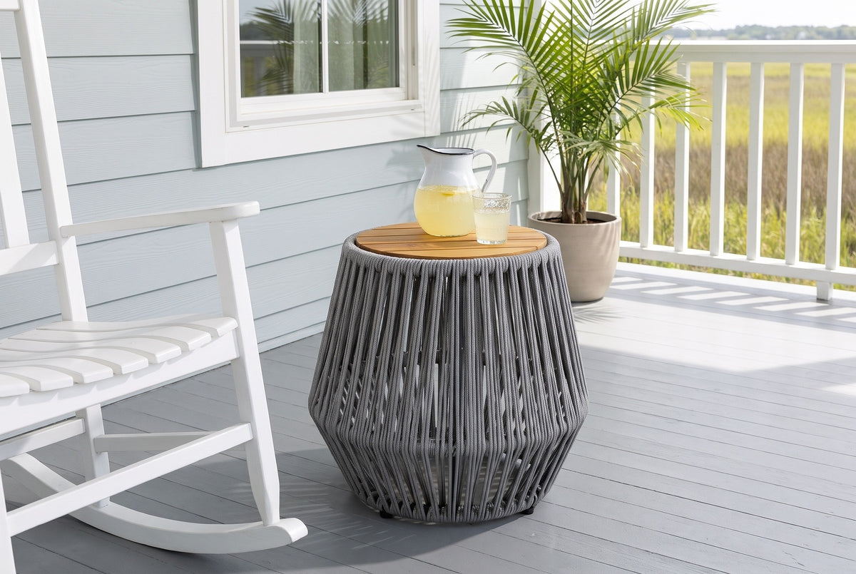 Naro rope side table with a pitcher of lemonade beside a white rocking chair on a Beaufort, South Carolina porch, a blue-grey shiplap wall and the marsh beyond (chair and decor not included)