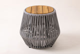 The Naro side table seen from the front: the round slatted top and the flared grey rope body