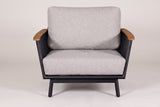 One Naxos chair seen from the front: two flared perforated sides with teak tops, one seat cushion and one back cushion