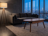 Neive 47-Inch Oval Walnut-Stained Solid Oak Coffee Table with 2 Drawers on a wool rug in front of a velvet sofa in a city penthouse at blue hour