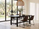 Nicastro 64-Inch Antique Black Farmhouse Dining Set with 4 Chairs in a sunlit villa dining area with olive trees outside