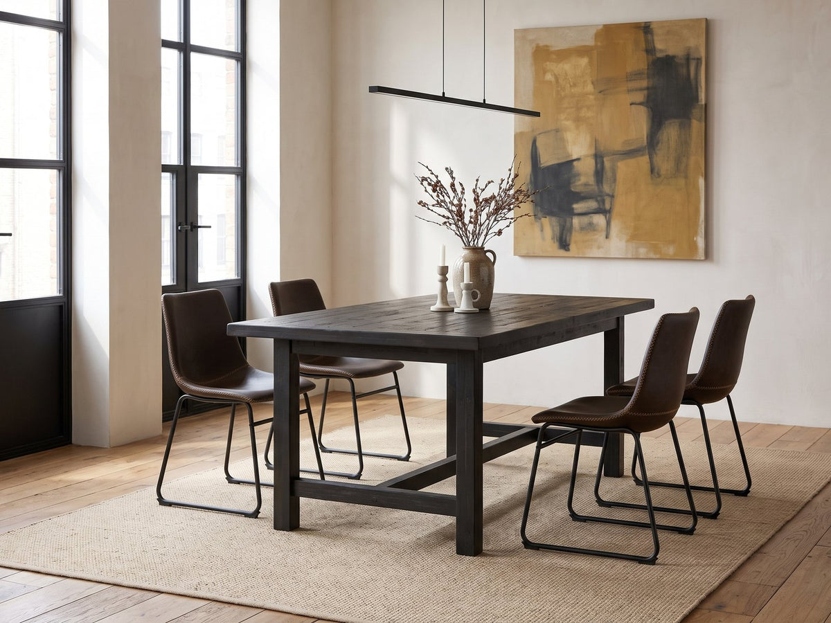 Nicastro 64-Inch Antique Black Farmhouse Dining Set with 4 Chairs in an industrial loft dining area