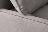 Close-up of the grey outdoor fabric on the Nicosia sofa: the woven texture, a cushion seam and the flange edge of a throw pillow
