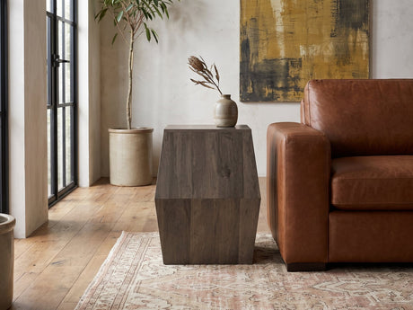 Nicotera Ash Grey Mango Faceted Side Table beside a leather sofa in an industrial loft