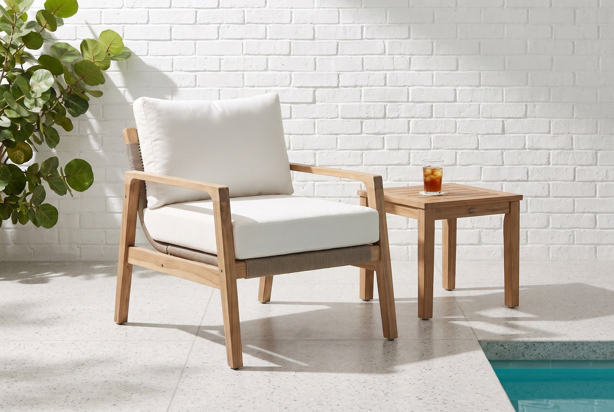 Niscemi acacia rope club chair on a terrazzo lanai in Sarasota, a white-painted brick wall and the corner of a pool (side table not included)