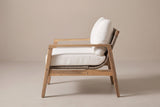 The Niscemi club chair seen from the side: flat arm rail, straight front leg, raked back leg and the curve of the rope sling