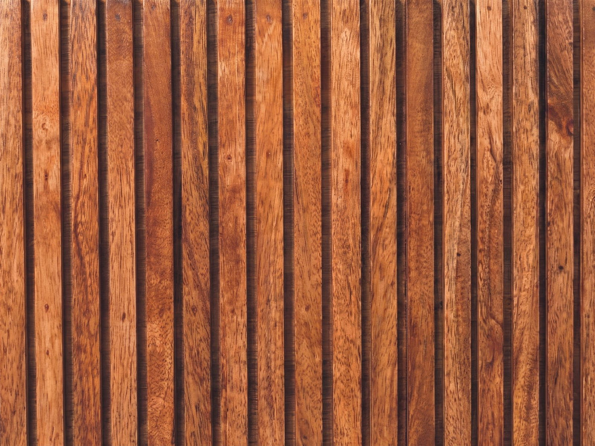 Close-up of the Noale 28-Inch Honey Caramel Solid Mango 3-Drawer Chest: the vertical mango ribs of a drawer front