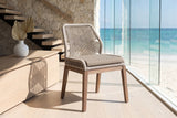 Nocera Woven Rope and Mahogany Dining Chair in an oceanfront glass house
