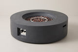 The Noto round fire pit in dark gray concrete, three-quarter view on a light studio backdrop, with the control niche on the front and a handle slot in the side