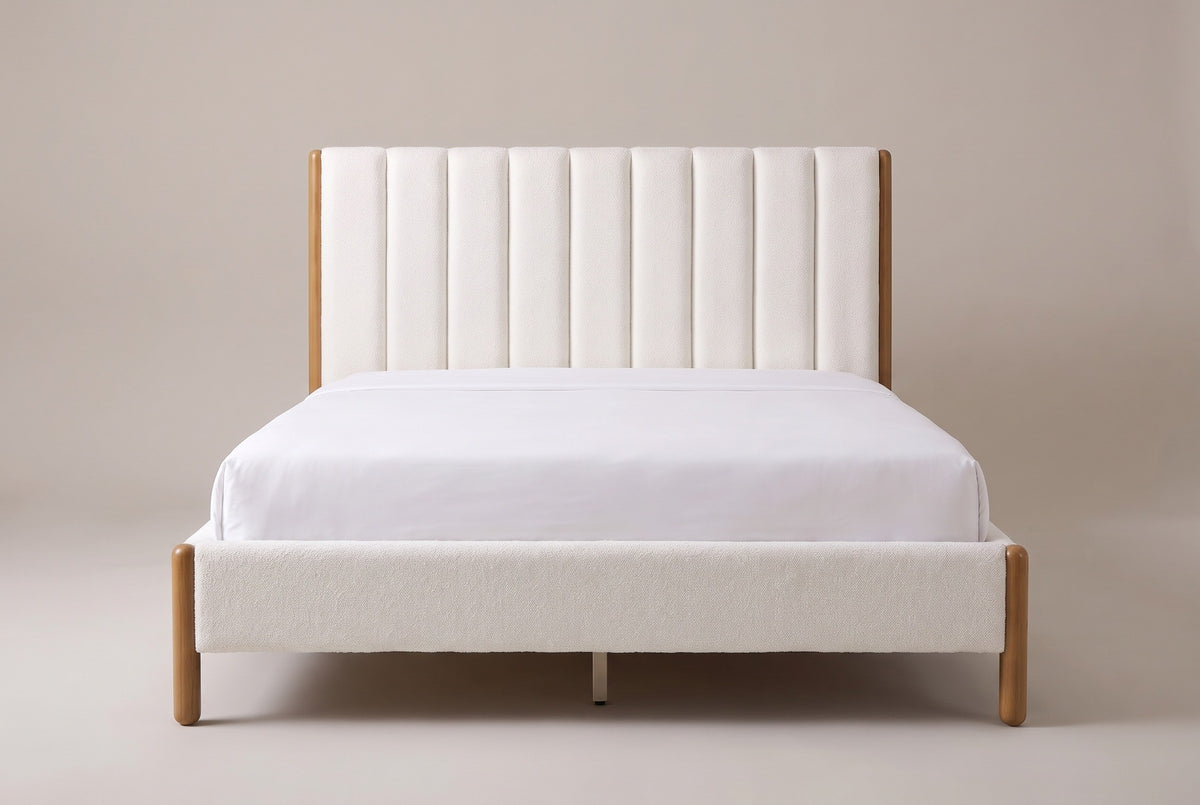 Ofena white boucle channel bed with a white mattress and pillows (not included), front view, Queen shown