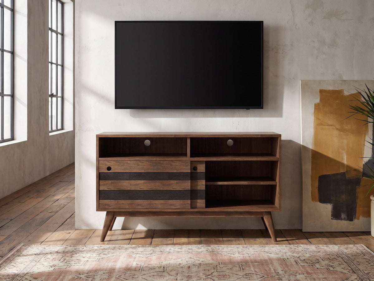 Offida Two-Tone Acacia Media Console under a wall-mounted screen in an industrial loft
