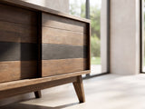 Close-up of the Offida Two-Tone Acacia Media Console: the sliding door front in alternating brown and charcoal acacia planks and the tapered leg below