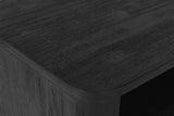 Close-up of the Olbia nightstand: black wire-brushed acacia with fine grey grain lines and a softly rounded top edge