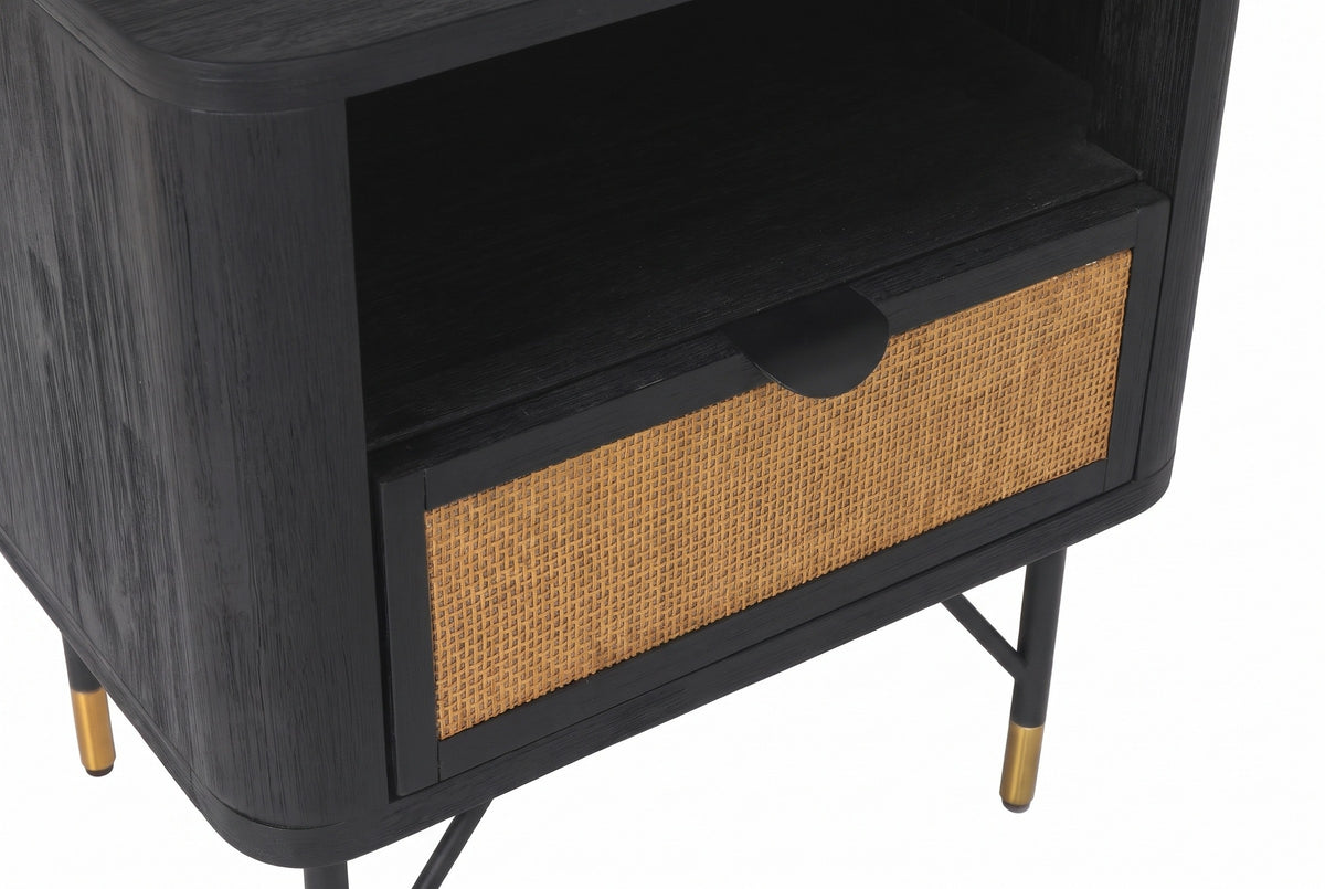 The drawer of the Olbia nightstand: woven cane in a black frame with a small black half-moon pull at the top, under the open niche