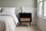 Olbia black acacia and rattan nightstand against a pale sage wall above white wainscot panelling in a Portland craftsman bedroom with pale ash floorboards