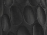 Close-up of the Olevano Carved Black Mango Pedestal Side Table: the hand-carved oval scoops of the base