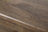 Close-up of the grey-washed mango wood on the Oristano nightstand: a muted grey-brown grain with a softly rounded edge