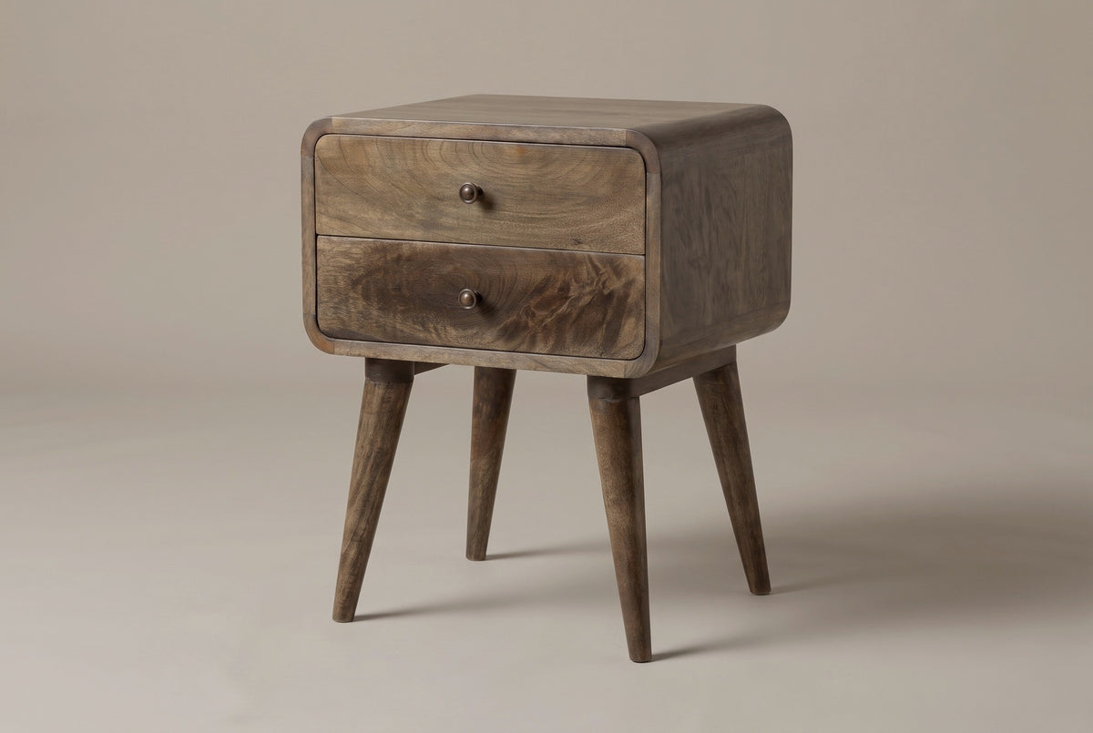 The Oristano nightstand in grey-washed mango, three-quarter view on a light studio backdrop