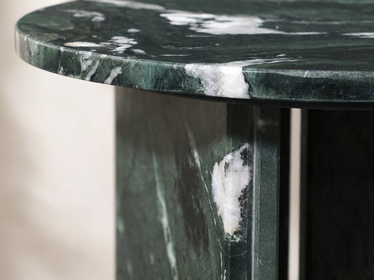 Close-up of the Orosei Verde Marble Round Side Table: the polished edge of the green marble top over a base slab
