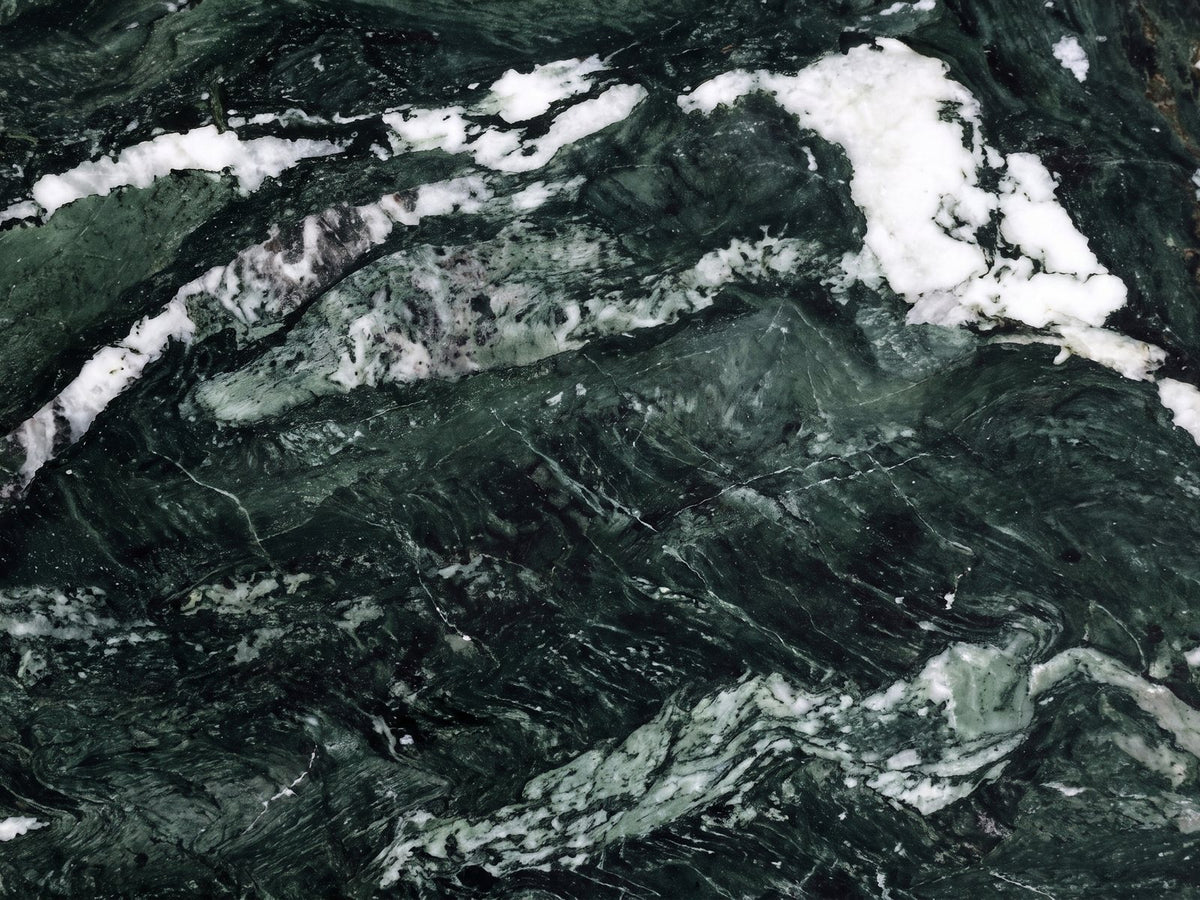 Close-up of the Orosei Verde Marble Round Side Table: the veining of the polished green marble top