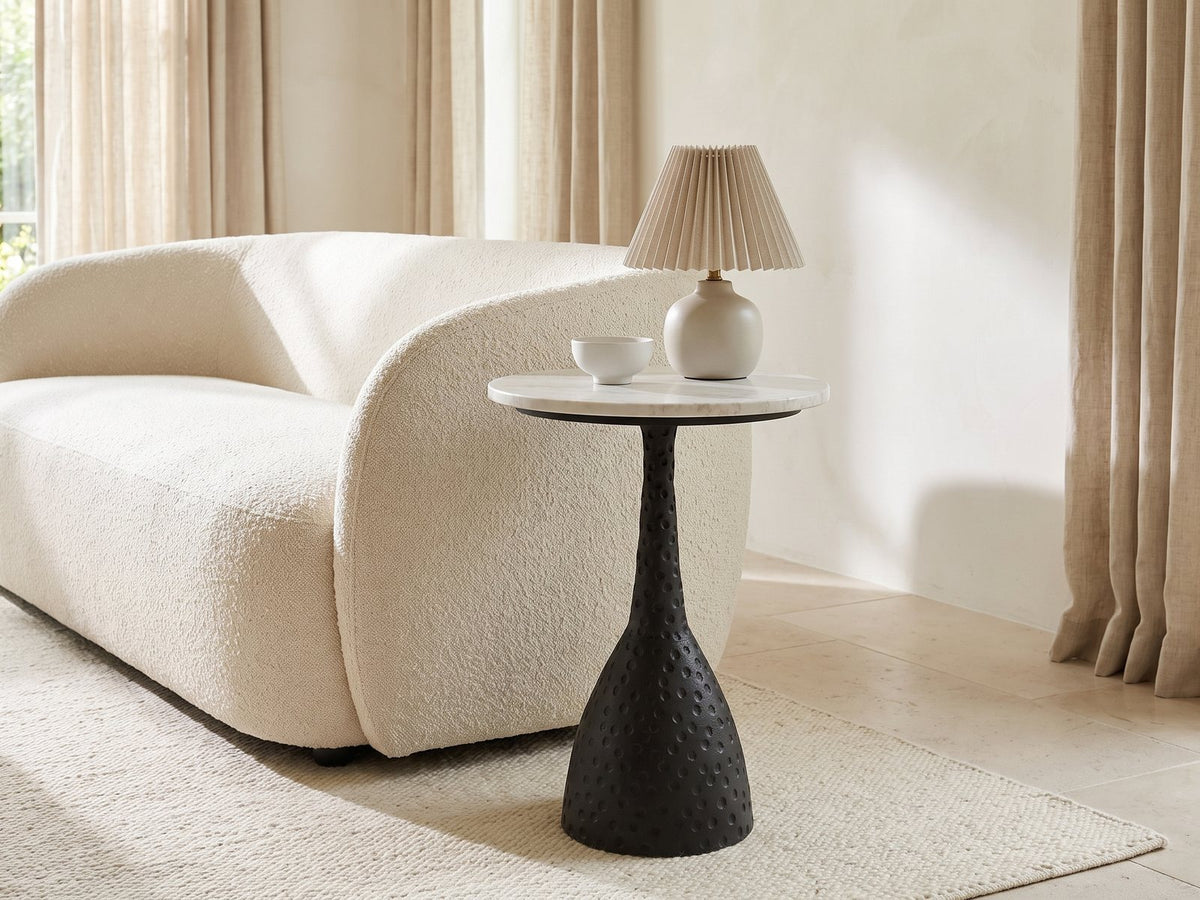 Orsara White Marble Pedestal Side Table with a lamp and a ceramic bowl beside a cream boucle sofa in a bright plaster room