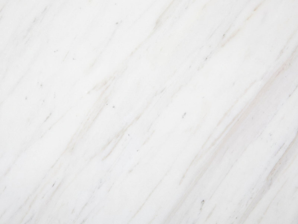 Close-up of the Orsara White Marble Pedestal Side Table: the genuine white marble of the top