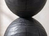 Close-up of the Orta Burnt Mango Hourglass Side Table: the narrow waist and the cracked charred grain of the lower dome