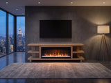 Ortisei Oak Fireplace Media Console with the fire lit in a city penthouse at dusk