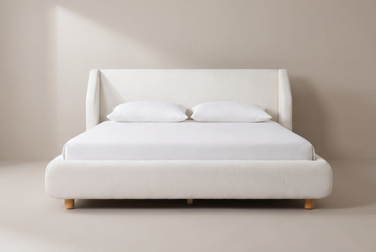 Pacentro bed in white boucle with a white mattress and pillows (not included), front view