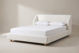 The Pacentro bed in white boucle with a white mattress and pillows (not included), three-quarter view on a light studio backdrop