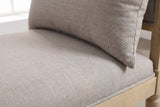Close-up of the greige woven fabric on the Paciano bench seat and pillow, with the welt along the seat edge and a little of the pale wooden frame