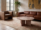 Paestum Rosa Marble Coffee Table on a vintage rug in front of a leather sofa in an industrial loft