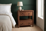 Palau solid neem nightstand against a deep forest green wall in a Brooklyn brownstone bedroom with a pale oak floor