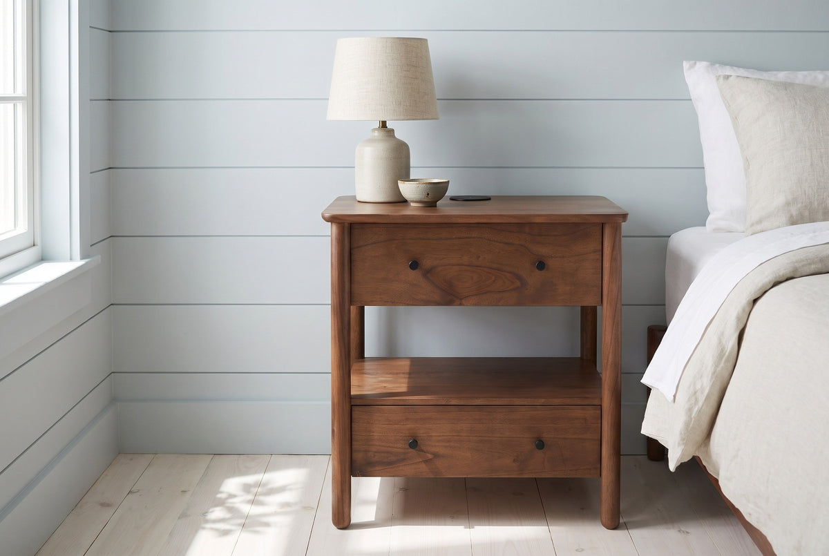 Palau solid neem nightstand with a ceramic lamp beside a bed in a Cape Cod bedroom with pale blue shiplap walls
