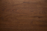 Close-up of the solid neem grain on the Palau nightstand: flowing figure, small knots and fine pores in a warm medium brown