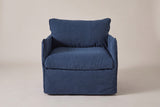 The Palazzolo club chair seen straight from the front: two slim arms, the back pillow and the skirt to the floor