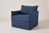 The Palazzolo slipcovered outdoor club chair in navy, three-quarter view on a light studio backdrop