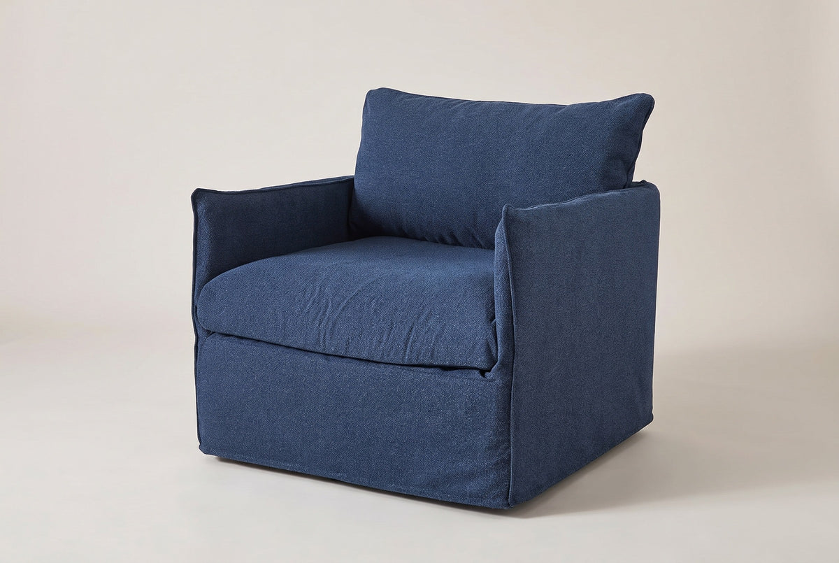 The Palazzolo slipcovered outdoor club chair in navy, three-quarter view on a light studio backdrop