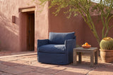 Palazzolo navy club chair in a Tucson adobe courtyard on red flagstone, a palo verde tree and a barrel cactus beside it (side table not included)