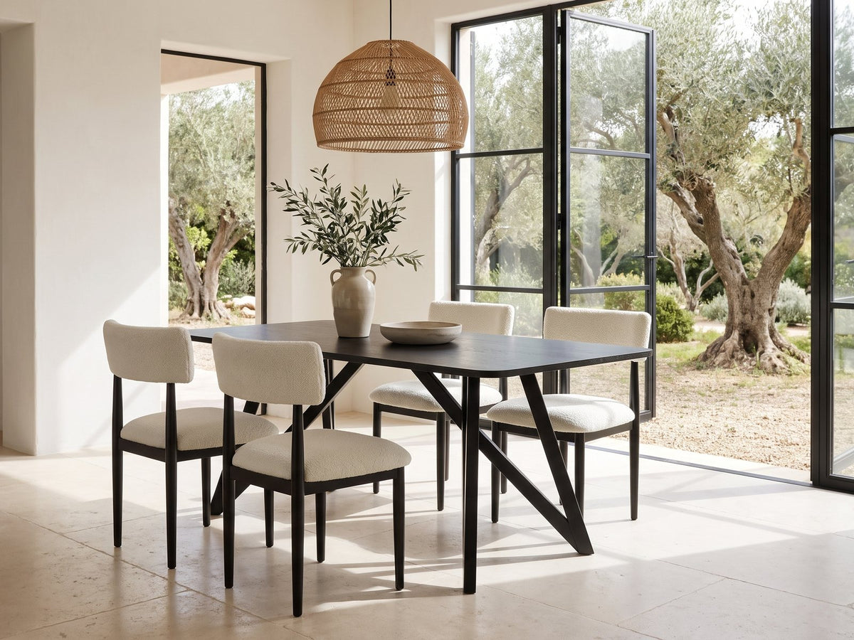 Palmi 70-Inch Black Oak Veneer Dining Set with 4 Boucle Chairs in a sunlit villa dining area with olive trees outside