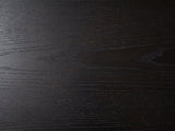 Close-up of the Palmi 70-Inch Black Oak Veneer Dining Set with 4 Boucle Chairs: the black-stained oak veneer top with its open grain