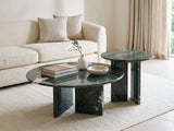 Panarea Verde Marble Nesting Coffee Tables, Set of 2 styled with books, a vase and a stone bowl in front of a cream sofa in a bright plaster room