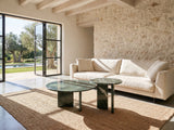 Panarea Verde Marble Nesting Coffee Tables, Set of 2 on a jute rug in front of a linen sofa in a poolside villa