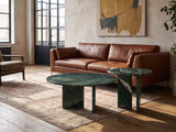 Panarea Verde Marble Nesting Coffee Tables, Set of 2 on a vintage rug in front of a leather sofa in an industrial loft
