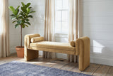 Panicale camel velvet bench under a window with linen curtains in a Hudson Valley sitting room with white shiplap walls and wide pine floorboards