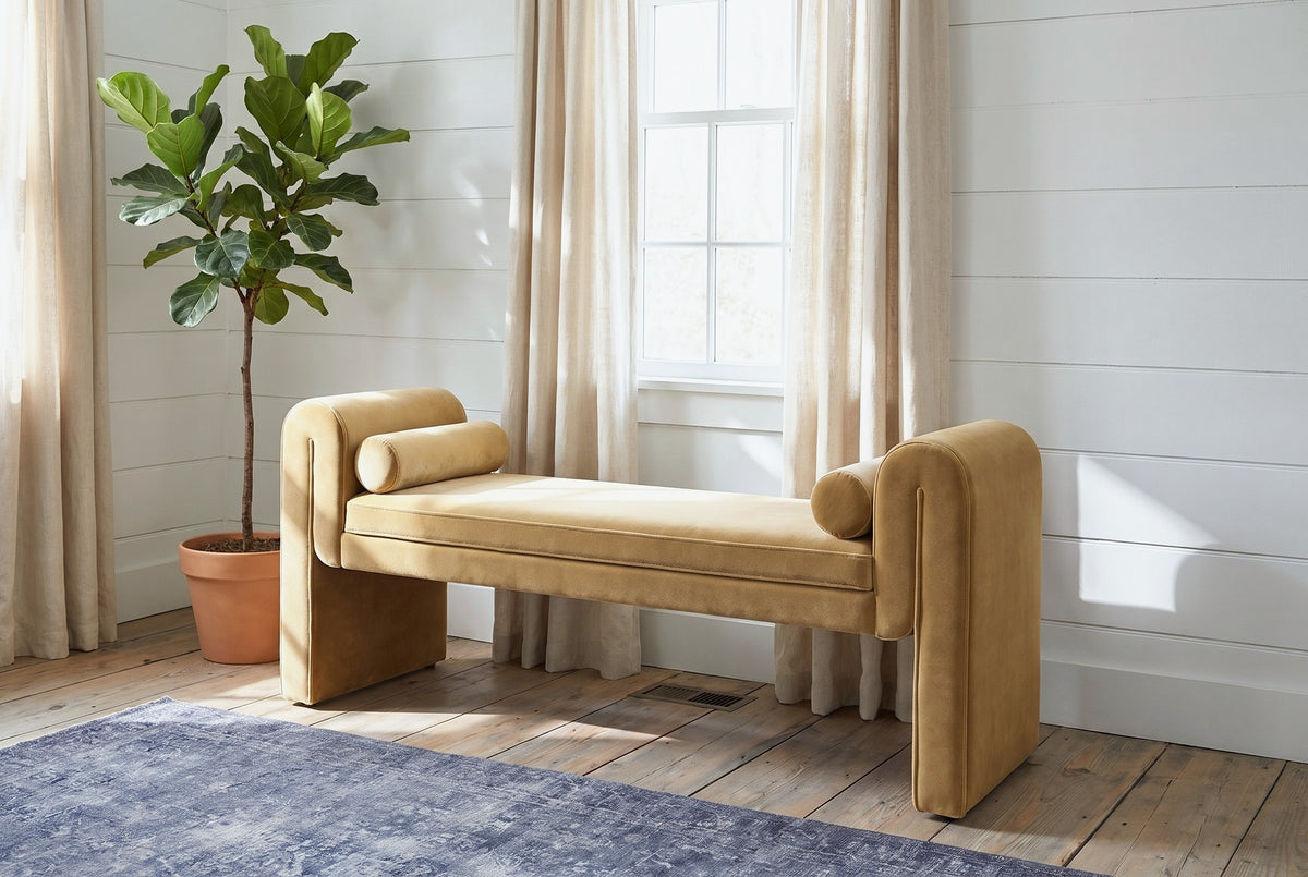 Panicale camel velvet bench under a window with linen curtains in a Hudson Valley sitting room with white shiplap walls and wide pine floorboards
