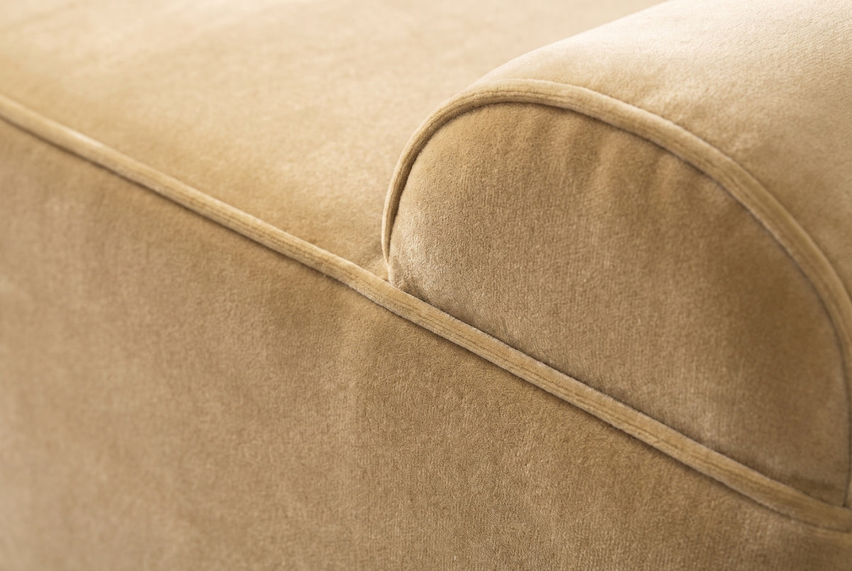 Close-up of the camel velvet on the Panicale bench: a short dense pile in warm golden tan with a thin welt seam