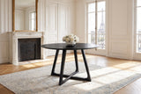 Paola 47.5-Inch Round Black Ash Dining Table in a Paris salon