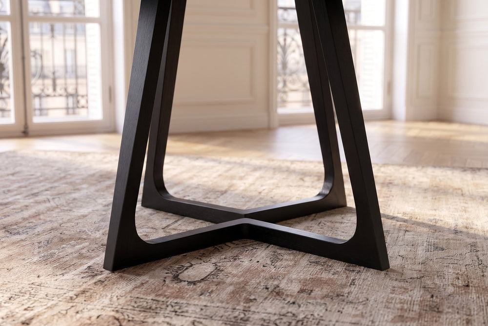 Close-up of the Paola 47.5-Inch Round Black Ash Dining Table: base